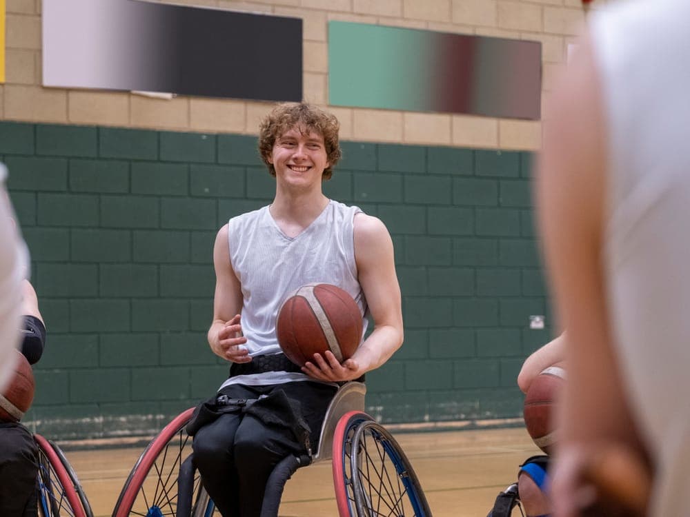 A participant enjoying a game of wheelchair basketball
